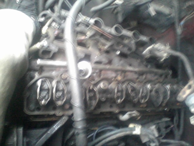 Close-up of engine valve train with visible rocker arms and springs