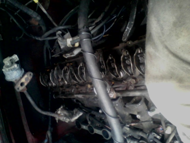 Engine valve train with rocker arms and pushrods visible