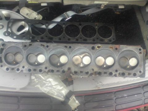 1988 Ford F-150 - Removed engine cylinder heads and gasket are laid out, possibly for repair or replacement.