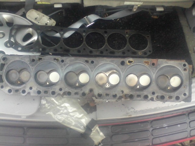 Engine cylinder heads and gasket removed from a vehicle