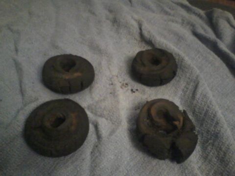 1988 Ford F-150 - Four old brake rotors are laid out on a gray towel, showing signs of wear and tear.
