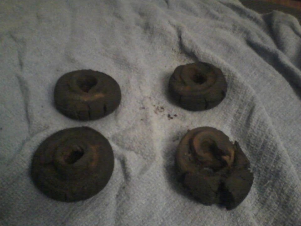 four old, worn brake rotors on a towel