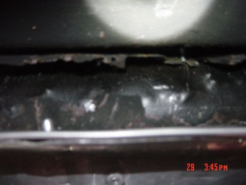 1988 Ford F-150 - Close-up view of the underside of a vehicle's frame, showing some rust and wear. A timestamp is visible in the lower right corner.
