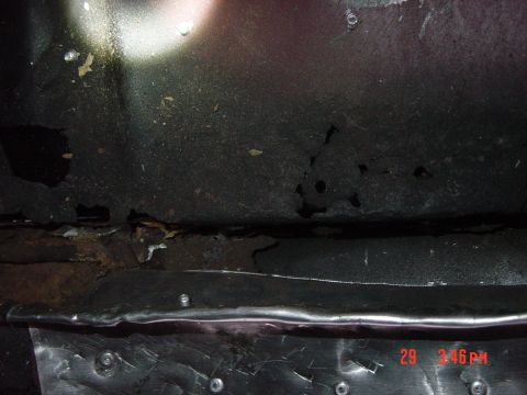 1988 Ford F-150 - The underside of a vehicle displays significant rust and damage, with a timestamp and website visible in the lower right corner.