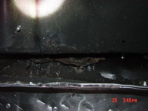1988 Ford F-150 - The underside of a vehicle shows significant rust and structural damage, indicating poor condition.