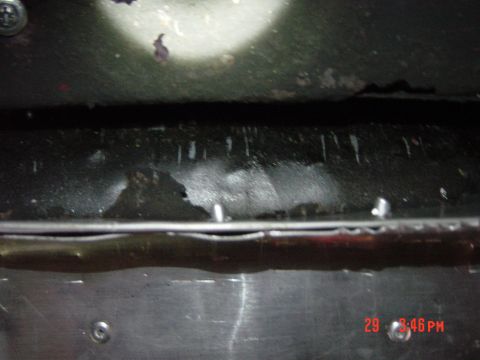 1988 Ford F-150 - Close-up of the underbody showing fluid leaks and some surface corrosion.