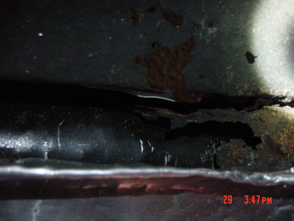 1988 Ford F-150 frame with significant rust and damage