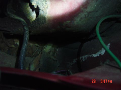 1988 Ford F-150 - The underside of a vehicle shows significant rust and exposed wiring, indicating potential structural issues.