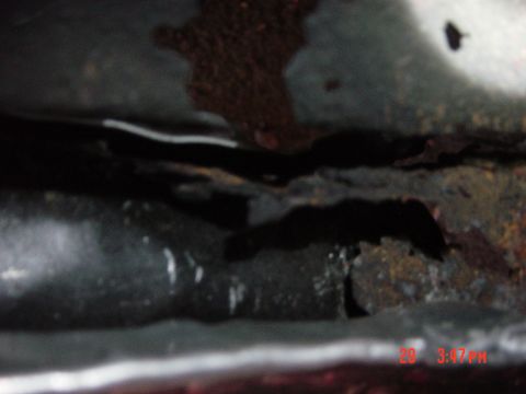 1988 Ford F-150 - Close-up of heavily rusted metal frame, possibly from a vehicle chassis.