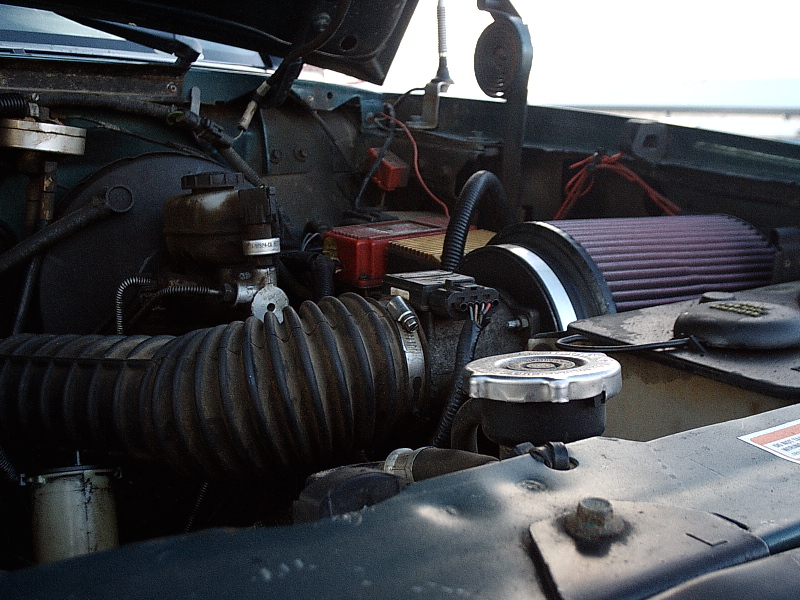 Engine bay with black intake tube and aftermarket cone air filter