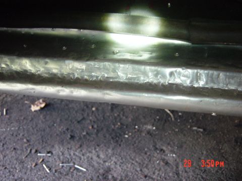 1988 Ford F-150 - A close-up view of a dented metal panel, possibly from a vehicle, with visible rivets and a timestamped watermark.