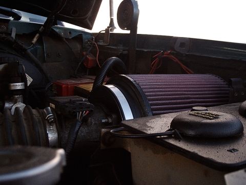 1996 Ford Bronco - Close-up view of a vehicle's engine bay, highlighting an aftermarket air filter and various engine components.