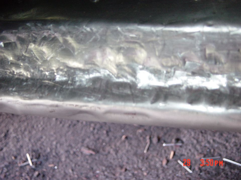 Close-up of a metal panel with visible weld marks and texture