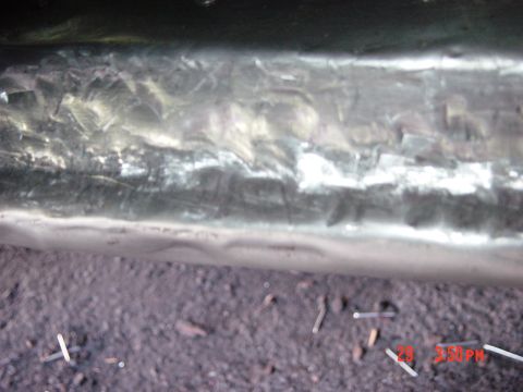 1988 Ford F-150 - Metal surface with visible weld marks and texture, likely a vehicle part.
