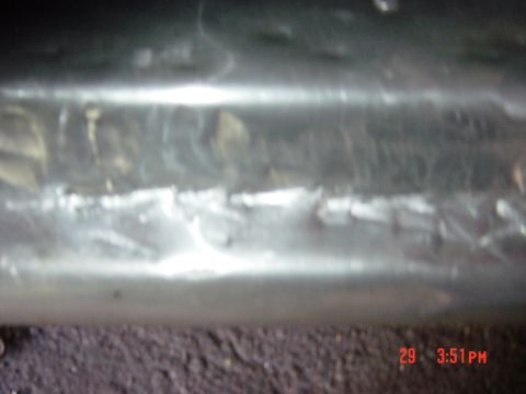1988 Ford F-150 - Close-up view of a metal pipe showing weld seams and texture.