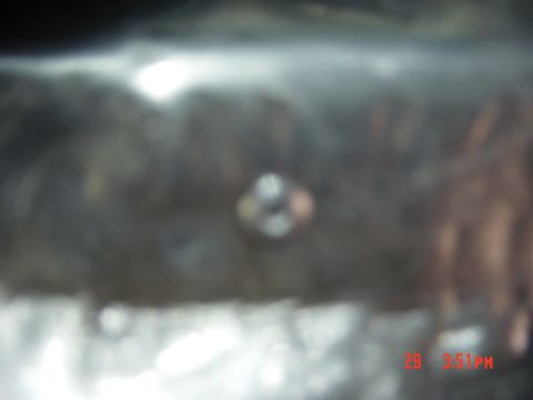1988 Ford F-150 - Close-up of a metal surface with a bolt, likely a vehicle part.
