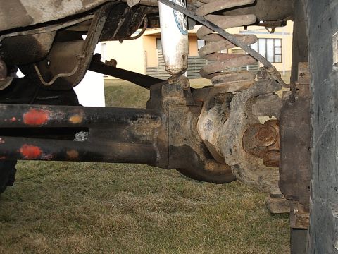1996 Ford Bronco - The photo shows the underside of a vehicle, focusing on the front axle and suspension system.