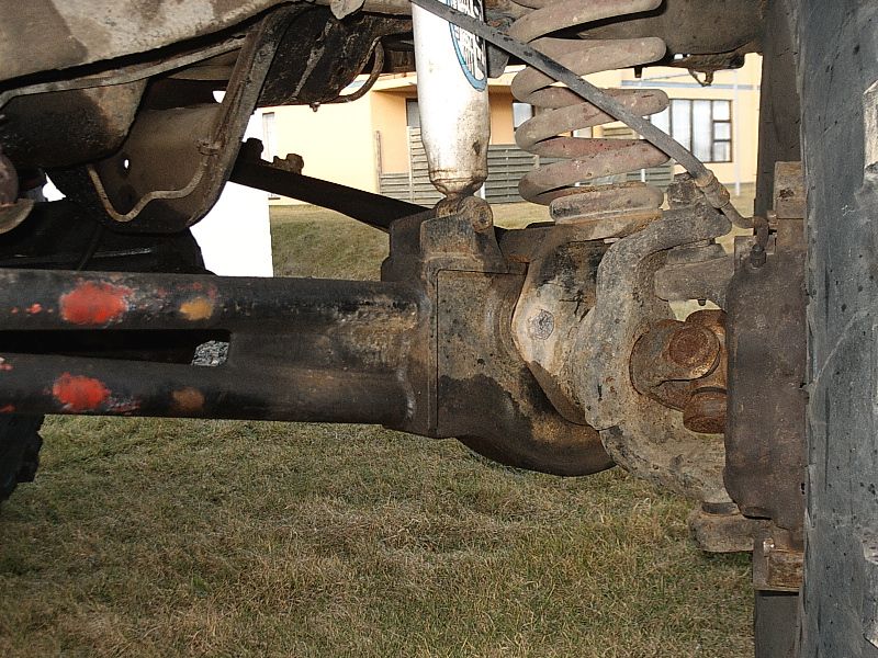 Front axle differential, driveshaft, coil spring and shock underneath a lifted 4x4