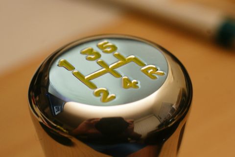 1995 Ford Taurus - Close-up of a chrome shift knob displaying a yellow gear pattern for a manual transmission.