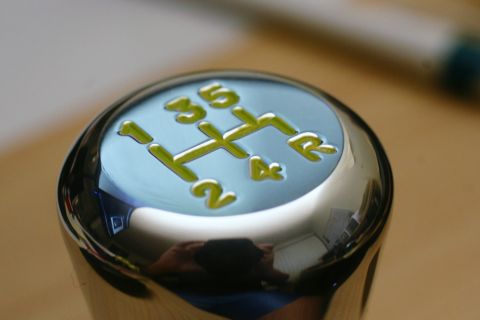 1995 Ford Taurus - Close-up of a chrome shift knob displaying a 5-speed manual transmission pattern.