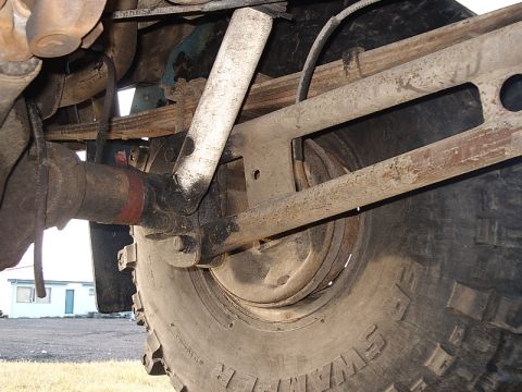 1996 Ford Bronco - Close-up view of the undercarriage, focusing on the rear suspension and tire.