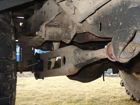 1996 Ford Bronco - Close-up view of the undercarriage, focusing on the suspension and drivetrain elements of an unidentified vehicle.