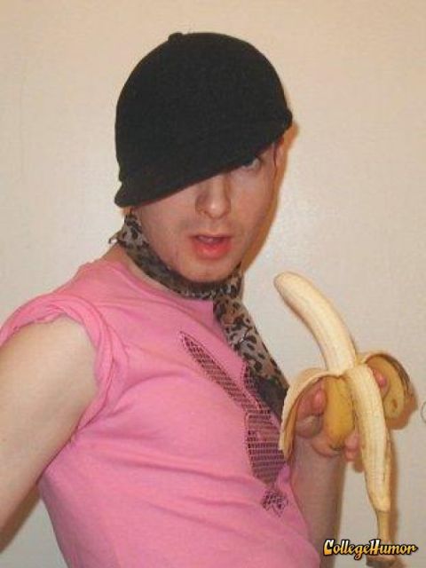 1989 Ford Bronco - A person in a pink shirt and black hat holds a peeled banana, with a leopard print scarf around their neck.