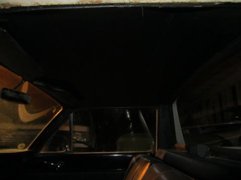 1964 Ford Ranchero - The interior of the vehicle shows the headliner and a view through the side window at night.