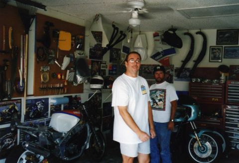 1999 Ford Ranger - Garage scene with two men, a partially assembled motorcycle, and a cruiser motorcycle.