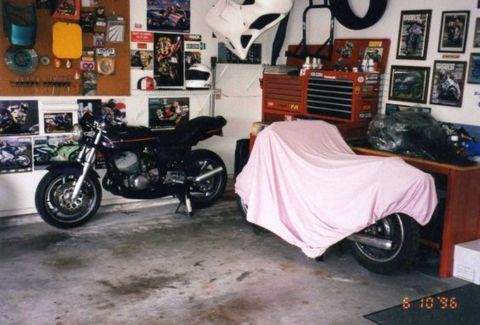 1999 Ford Ranger - A garage scene with two motorcycles, one of which is covered by a pink sheet.