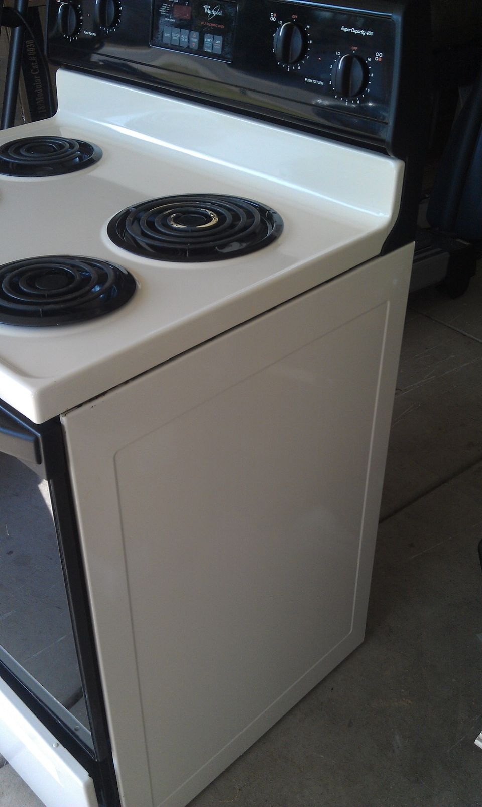 White electric stove with four burners and control panel