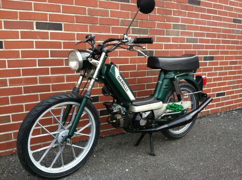 1981 Garelli Rally Sport - Green moped parked against a brick wall. The 'GARELLI' logo is visible on the fuel tank.