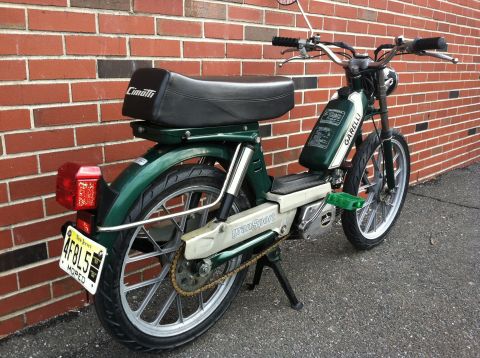 1981 Garelli Rally Sport - This green moped, identified as a Garelli Rally Sport, is seen parked against a brick wall.