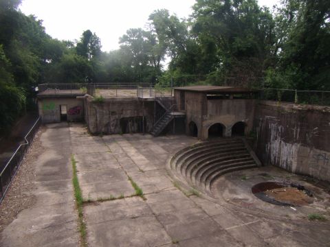 2003 Jeep Wrangler - An abandoned concrete structure with stairs and arched openings, surrounded by trees.