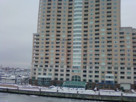 2003 Jeep Wrangler - A tall building stands beside a marina filled with boats covered in snow.