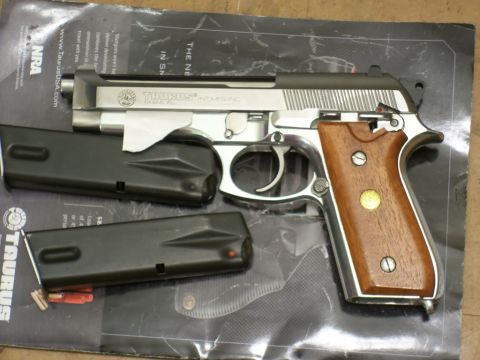 2000 Mercury Grand Marquis - Taurus PT92 AF pistol stainless steel construction, wood grips, and two accompanying magazines.