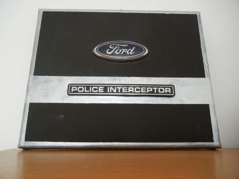 1999 Lincoln Town Car - A Ford Police Interceptor plaque is displayed on a wooden surface.