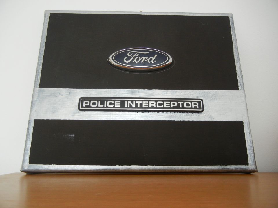 Black and silver plaque with Ford logo and "POLICE INTERCEPTOR" text