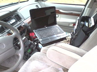 1997 Mercury Grand Marquis - Laptop mounted on a stand in the passenger seat of a 1997 Mercury Grand Marquis.
