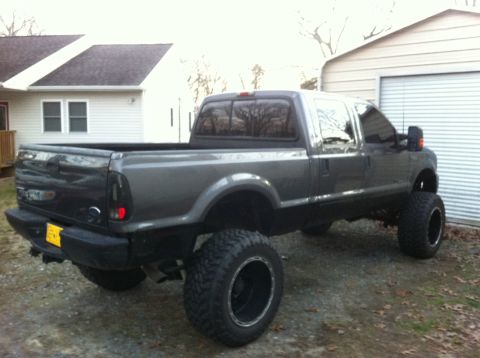 1988 Ford Bronco - This lifted Ford F-250 Super Duty pickup truck is shown from a rear three-quarter view.