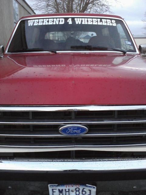 1989 Ford Bronco - Front view of a red 1989 Ford Bronco, a prominent Ford emblem on the grille.