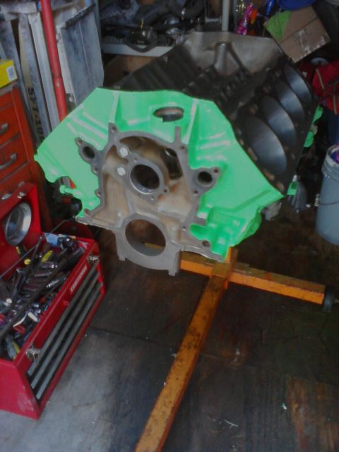 1989 Ford Bronco - An engine block is mounted on an engine stand in a garage setting, with a toolbox visible.