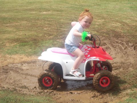 1989 Ford Bronco - A young child navigates an ATV through a muddy field, demonstrating off-road capabilities.
