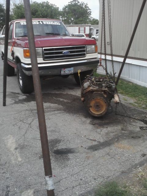 1989 Ford Bronco - Ford F-Series pickup truck with an engine being removed or installed.