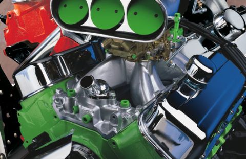 1989 Ford Bronco - A highly customized V8 engine features a green block, polished chrome components, and prominent triple green air intake scoops.