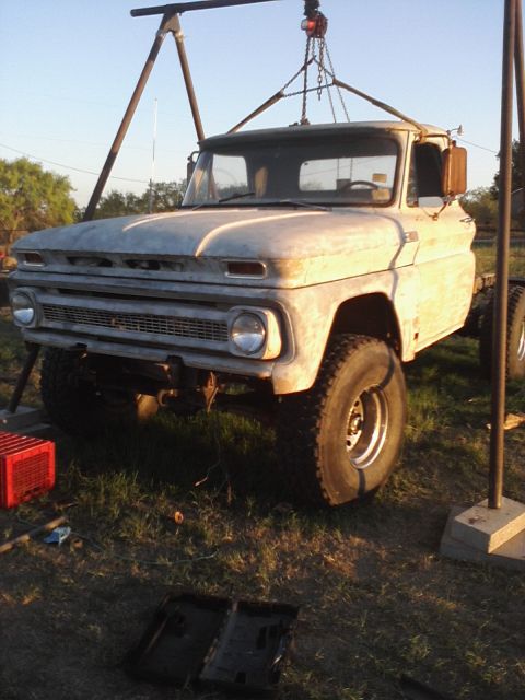 1989 Ford Bronco - This 1966 Chevrolet C10 pickup truck is being lifted by a gantry crane.