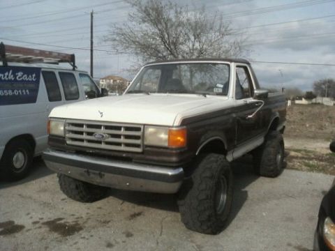 1989 Ford Bronco - This lifted Ford Bronco has a two-tone paint scheme and aggressive off-road tires.