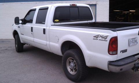 2002 Ford F-250 - This 2002 Ford F-250 pickup truck is shown from the rear 3/4 angle, its '4x4 OFF ROAD' decal and Tennessee license plate.