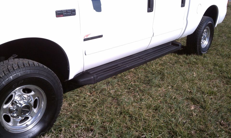 White 2002 Ford F-250 side view with running boards and F-250 badge