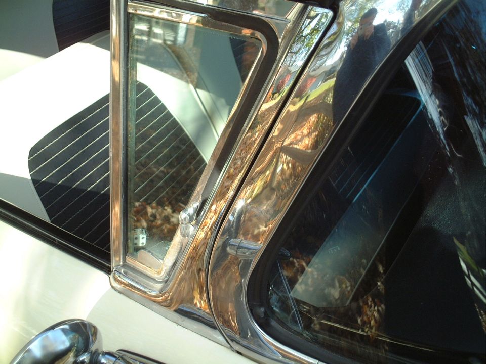 Close-up passenger door 1/4 window (some pitting on the chrome), chrome around windshield is excellent though